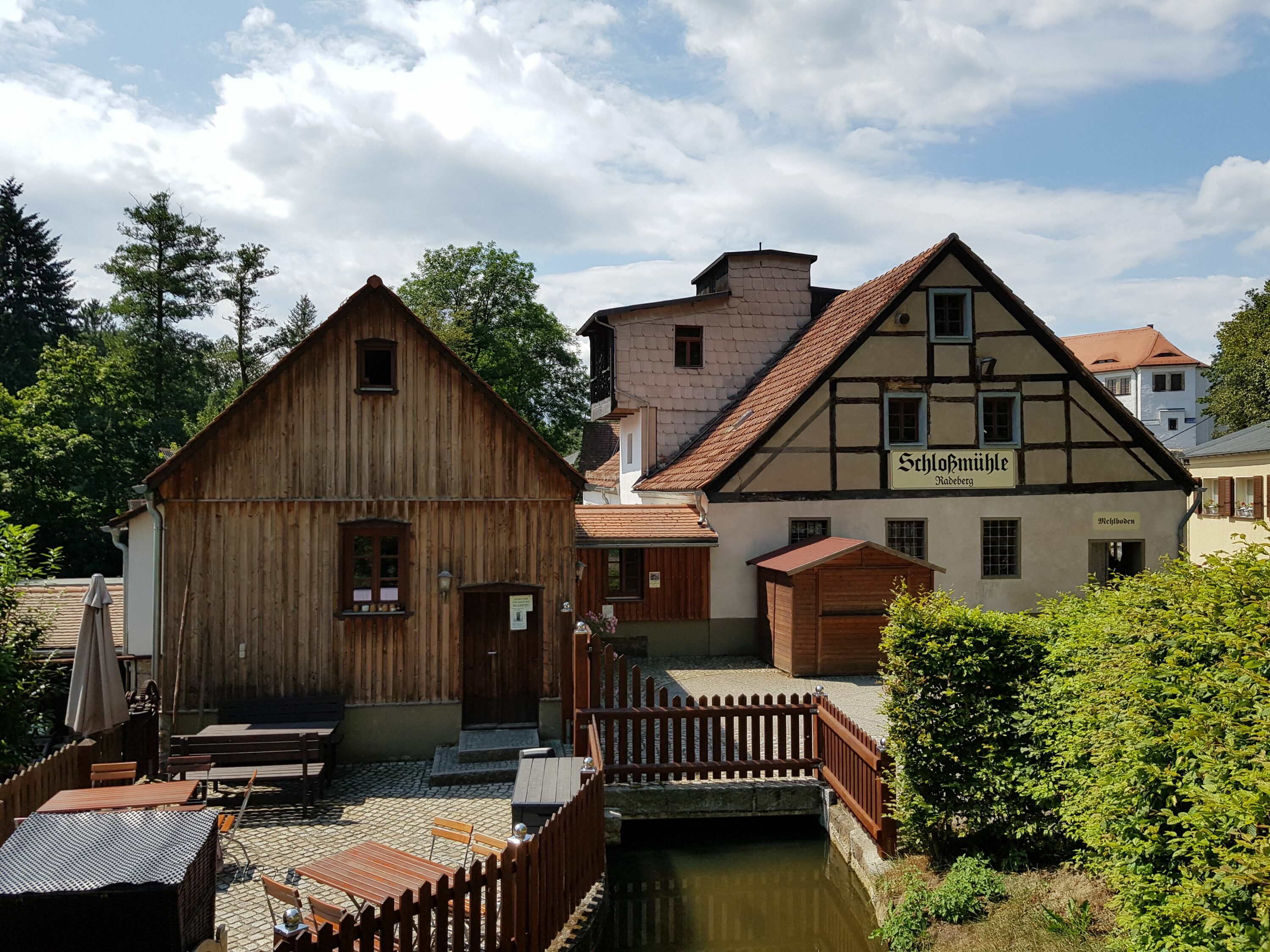 Blick vom Hüttertal auf die Schlossmühle mit Müllerstube und Biergarten