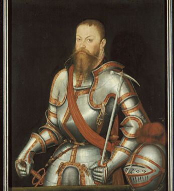 Bildnis von Kurfürst Moritz in einer Rüstung. Der Helm ist abgesetzt. Man sieht den Vollbart des Kurfürsten.
